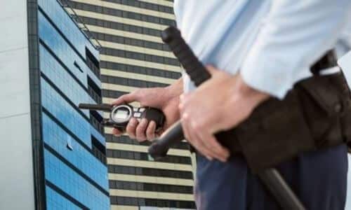 vigilante che controlla che all'esterno dell'edificio che controlla sia tutto in ordine